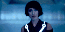 a woman in a black dress with a glowing collar