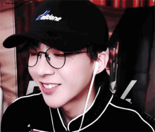 a man wearing glasses and a hat that says falcone is smiling