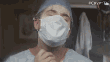 a man wearing a surgical mask with #crypttv written in the upper right corner