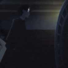 a man in a black suit is holding a shield