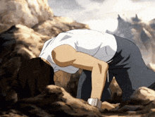 a man in a white shirt and black pants is bending over on the ground