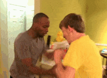 a man in a yellow shirt is talking to another man