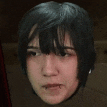 a close up of a person 's face with a vampire piercing in their mouth .