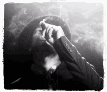 a man in a hat is smoking a cigar