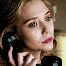 a close up of a woman 's face talking on a phone with the word chases visible