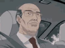 a bald man in a suit and tie is sitting in the driver 's seat of a car .