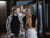 a man and a woman are standing next to each other in front of a phone booth that says ' star ' on it