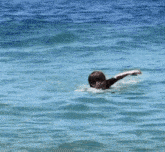 a person is swimming in the ocean with their head above the water
