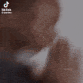 a man is praying with his hands together in a blurry photo .
