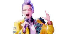 a woman in a yellow jacket singing into a microphone with the word attitude on it