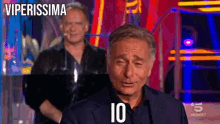 a man in a suit with the number 10 written on his shirt