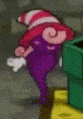 a purple cartoon character with a red and white hat on