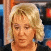 a close up of a woman 's face with a blurred background