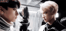 two young men are looking at each other with a sign that says the record