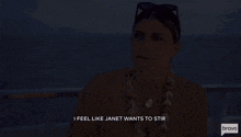 a woman wearing a lei and sunglasses says i feel like janet wants to stir