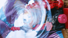 a purple and blue swirl is coming out of a red toy
