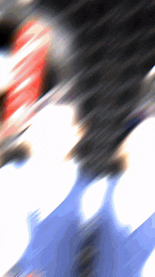a blurred image of a person 's face with a red and white stripe