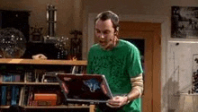 a man is using a laptop computer in a living room .