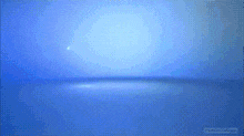 a blue background with a glowing object in the middle of it .