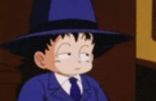a boy in a suit and tie is wearing a blue hat and making a funny face .