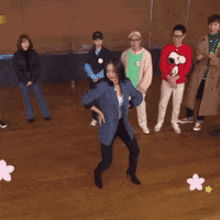 a group of people are standing around a woman in a snoopy sweater