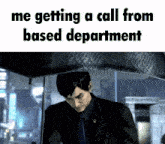 a man in a suit and tie is under an umbrella with the words me getting a call from based department