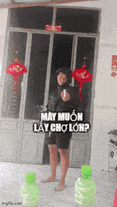 a man standing in front of a door with a bottle of water in front of him that says may muon