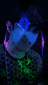 a man wearing a hat that says python is surrounded by purple lights