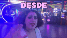 a woman in an amusement park with the word desde above her