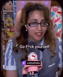 a woman with glasses and a hello kitty microphone says go f*ck yourself