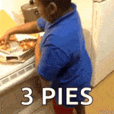 a boy in a blue shirt is taking a pizza out of a box with the words 3 pies above him