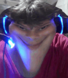 a person wearing headphones and a red shirt is making a funny face .