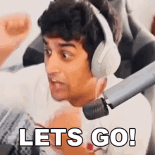 a man wearing headphones is saying let 's go !