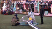 a group of people are sitting in a clear dome with a sign that says colors hd