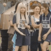 a group of girls are standing next to each other in a field .