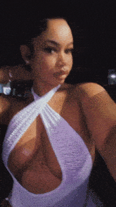 a woman taking a selfie in a very revealing white dress