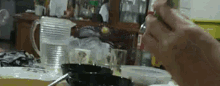 a person is sitting at a table with a spoon in their hand .