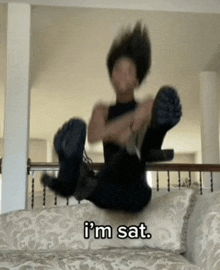 a person sitting on a couch with the words i 'm sat written on the bottom