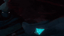 a person is standing in front of a dragon with a red light coming out of it 's mouth .