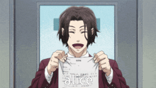 a man holding up a piece of paper with the word alice on it