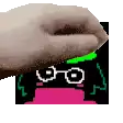 a close up of a person 's hand holding a picture of a cartoon character with glasses .