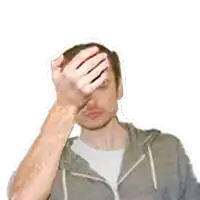 a man in a grey hoodie wipes his forehead with his hands