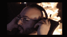 a man wearing glasses and headphones looks at something