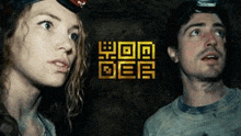 a man and a woman are looking up in a cave .