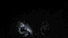 a close up of a person 's face with a glowing eye in the dark .