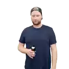 a man wearing a hat and a blue shirt drinks from a bottle