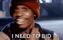 a man wearing a red beanie is smiling and says `` i need to bid '' .