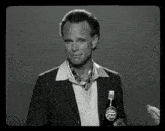 a man holds a bottle of nuka cola