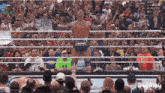 a man in a wrestling ring with a sign that says shame on it