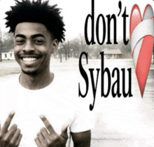 a young man giving the middle finger with the words do n't sybau behind him